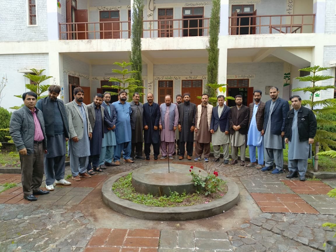 Staff group photo in front of the school building